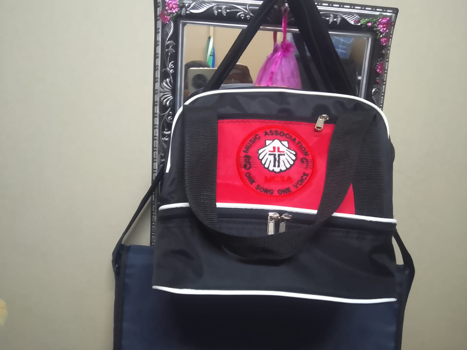 Black backpack with red and white embroidery